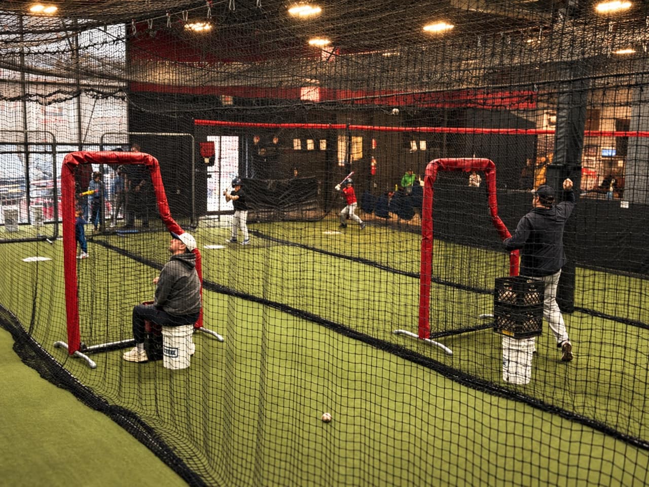 Young hitters taking swings in the cages