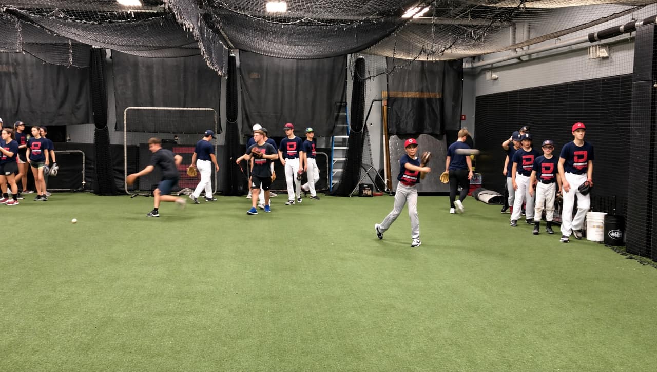 Players throwing and fielding on the academy turf