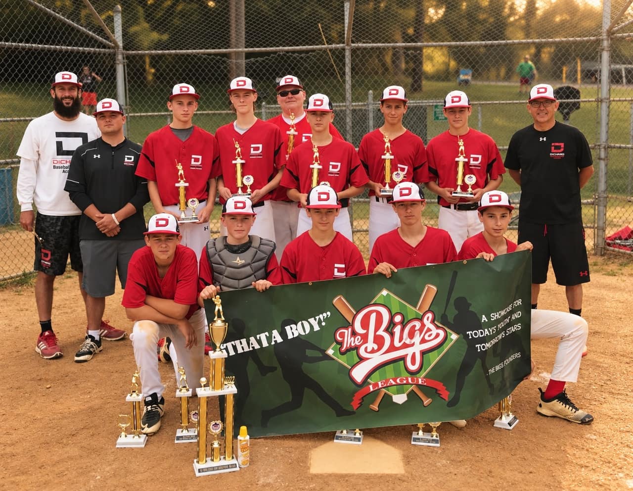 An academy team with its trophies after a tournament